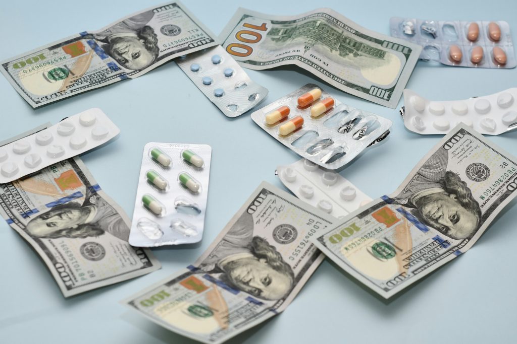 Money and Pharmaceuticals on a table